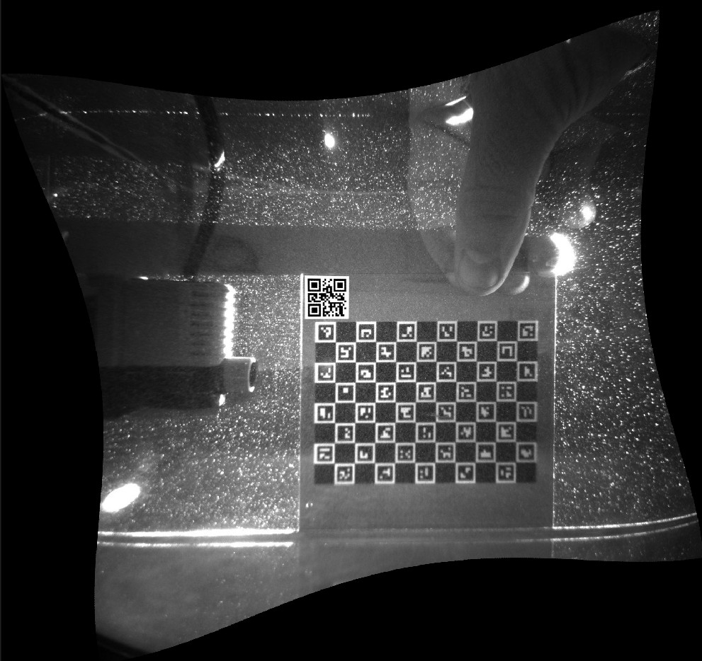 A calibration-target image after undistortion and rectification: originally straight edges now bow outward, showing the geometric correction that has been applied so the image plane matches the target